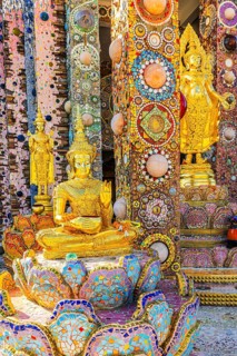 Gilded standing Buddha statues standing on pedestals decorated with mosaics and glass works of art,
