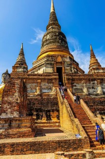 Visitors on steep stairs to the entrance of a temple tower, Prang, historic Buddhist temple