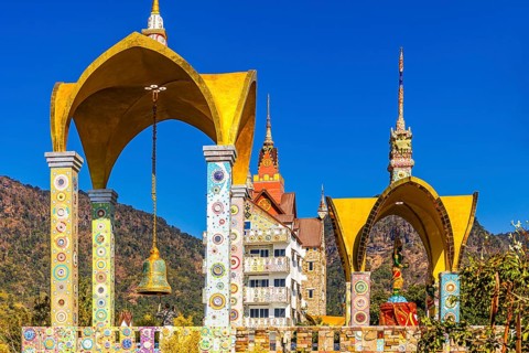 Round arch bell tower decorated with colorful mosaics and glass works of art, Buddhist temple