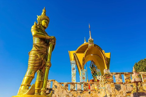 Round arch pavilions decorated with colorful mosaics and glass works of art, in front of a gilded