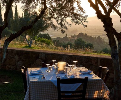 Outdoor table, surrounded by trees, in the warm light of a sunset, Hotel Europa, garden restaurant