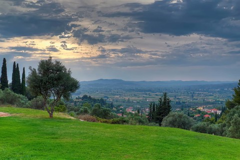 Wide landscape with a focus on a cloudy sky and isolated trees, Hotel Europa, garden restaurant and