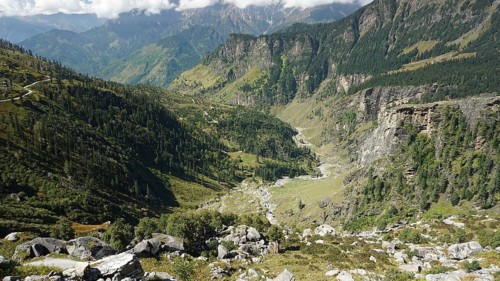 Landscape with low-lying valleys and a forested mountain range on the Manali-Leh Highway, Trekking