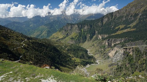 View of winding mountain roads on the Manali-Leh Highway and green slopes, trekking Ladakh,