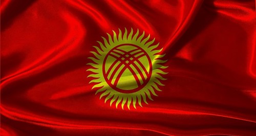 Kyrgyzstan flag with cloth textured background. National flag of Kyrgyzstan with realistic texture