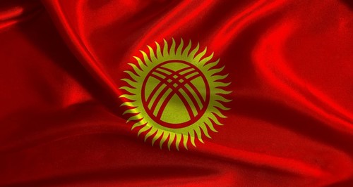 National flag of Kyrgyzstan with cloth texture. Kyrgyz flag with realistic texture background