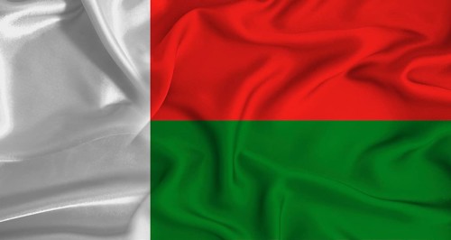 Realistic Madagascar flag waving. Close up of flag of Madagascar with cloth texture