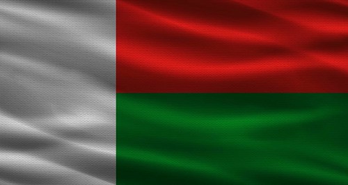 Malagasy flag with fabric texture. Realistic flag of Madagascar waving