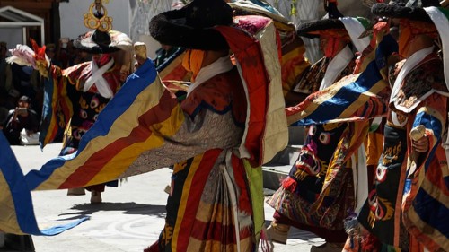 People wearing traditional garments dancing in festive community, Leh, trekking in Ladakh,