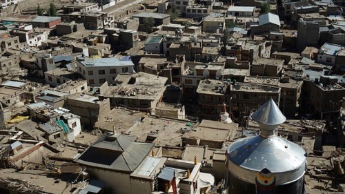 A variety of traditional buildings in a Tibetan village seen from above, trekking in Ladakh,