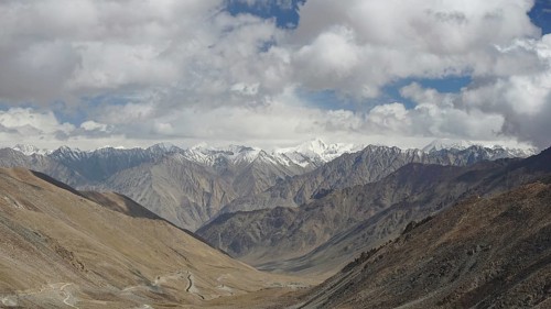 Panormama, panoramic view of a mountain valley with snow-capped peaks in the background, trekking