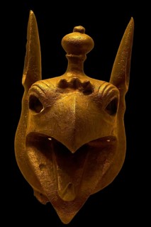 Bronze griffin protome, golden sculpture of a mystical animal head with detailed features, Olympia