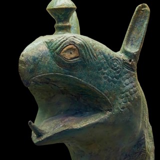 Bronze griffin protome, green-brown bronze depiction of an imaginary being with fine scale