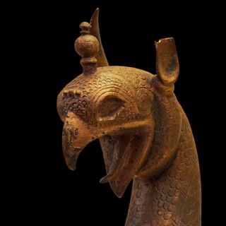 Bronze griffin protome, detailed bronze image of a mythological being with decorative headdress,