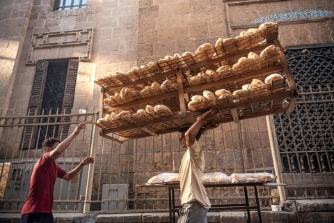 Cairo, Egypt. July 3rd 2024 Freshly baked Baladi bread being delivered by bicycle to a street stall