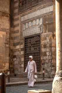 Cairo, Egypt. July 7th 2024 An Egyptian man wearing traditional clothes walks along the cobbled