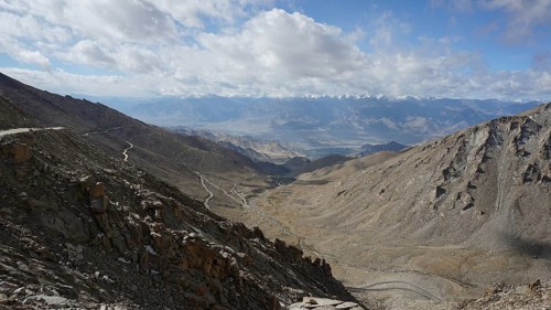 Barren mountain panorama with winding roads under a cloudy sky, trekking in Ladakh, Himalayas,
