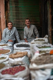 Cairo, Egypt. July 1st 2024 Two Egyptian men sit amongst sacks of spices in the Cairo spice market