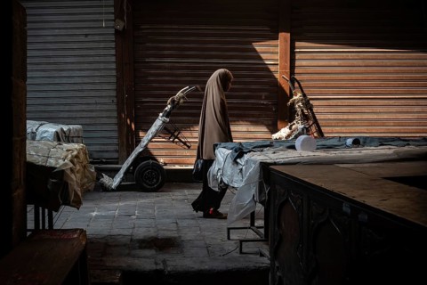 Cairo, Egypt. July 1st 2024 An Egyptian Muslim woman walks along the cobbled streets of a closed