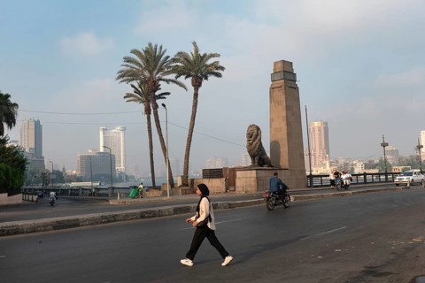 Cairo, Egypt. July 1st 2024 A young muslim Egyptian woman crosses Qasr El Nile Bridge in the early