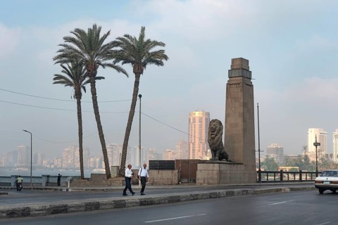 Cairo, Egypt. July 1st 2024 Two Egyptian men cross the Qasr El Nil Bridge during the early morning
