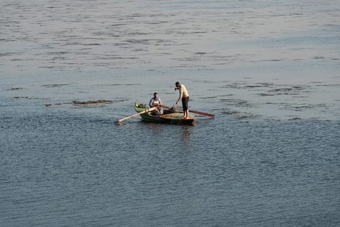 Qanater, Nile Delta. Egypt. December 18th 2022 Egyptian fishermen fishing from a small boat on the