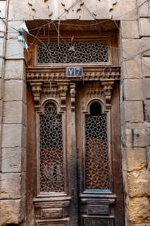 Cairo, Egypt. December 21st 2022 An antique wooden door of a house in the narrow alleyways of the