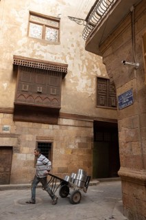 Cairo, Egypt. December 7th 2022 People walk by traditional Arabic Islamic architecture Mashrabiya