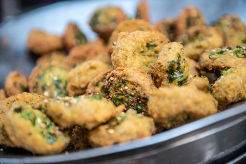 A close up detail of freshly cooked deep fried Falafel, a chickpea and herb filled snack popular in