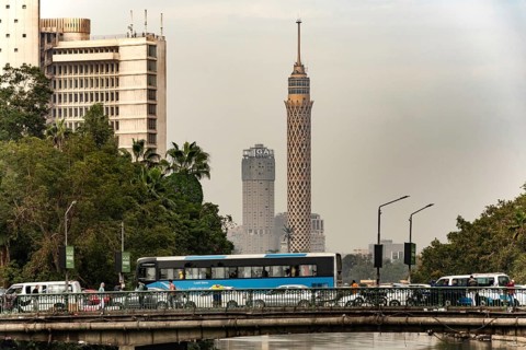 Cairo, Egypt, November 26th 2022 Egyptian commuter bus in traffic on a road bridge over the River