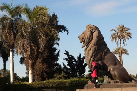 Cairo, Egypt. December 10th 2009 Young Egyptian Muslim women poses for photographs beside a statue