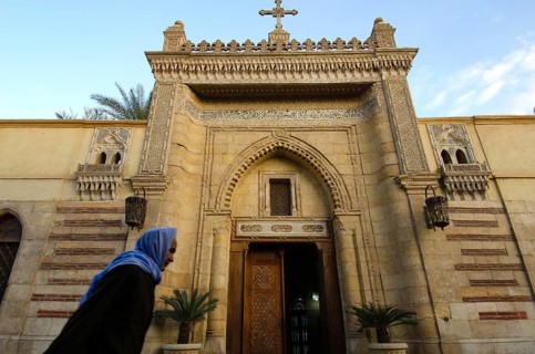 Cairo, Egypt. December 31st 2012 An Old Egyptian Copt walking past the entrance to the Hanging