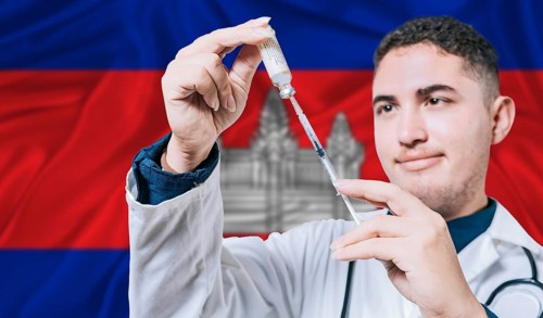 Doctor holding syringe on Cambodia flag background. Medical professional holding syringe with