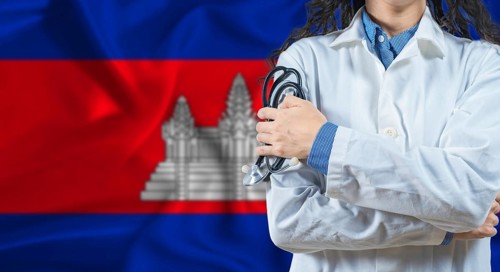 Healthcare professional with Cambodia flag background. Professional doctor holding stethoscope on