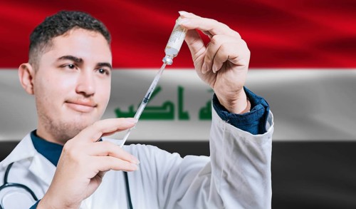 Doctor holding syringe on Iraq flag background. Medical professional holding syringe with Iraqi