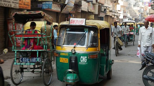 Busy street in India with rickshaws and people, dynamic city scene, Delhi