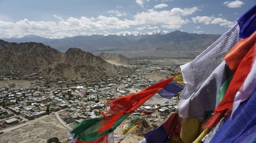 Colourful prayer flags fly over an expanding mountain town, Leh, Ladakh, North India, Himalayas,