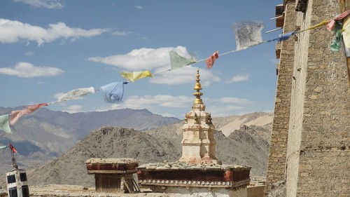 Traditional tower with prayer flags and mountain scenery in the background near Leh, Ladakh, North