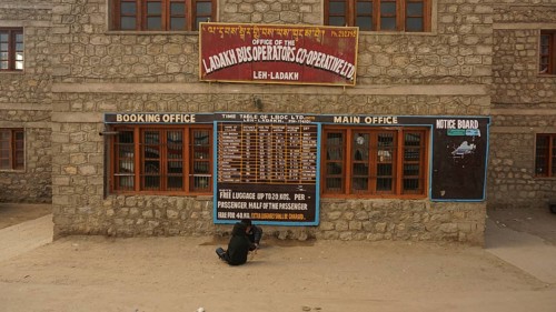 Ladakh bus operator cooperative stone building with signs and street view, Leh, Ladakh, North