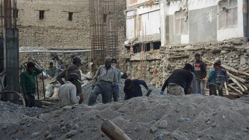 Workers on a construction site in Leh working on a building in harsh conditions, Ladakh, North