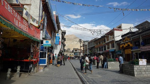 Busy street in Leh with traditional shops and flying prayer flags, Ladakh, North India, Himalayas,