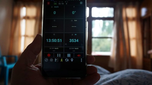 View of a smartphone showing altitude, interior view of a bedroom, Leh, Ladakh, North India,