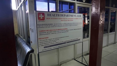 Information sign about altitude sickness at Leh airport with preventive measures in a building,