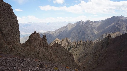 Rough, angular mountain formations under clear blue sky, trekking at Stok La Pass in Ladakh,