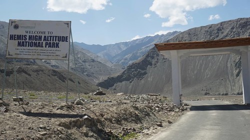 Entrance gate to Hemis National Park with sign and mountainous surroundings, Ladakh, Himalayas,