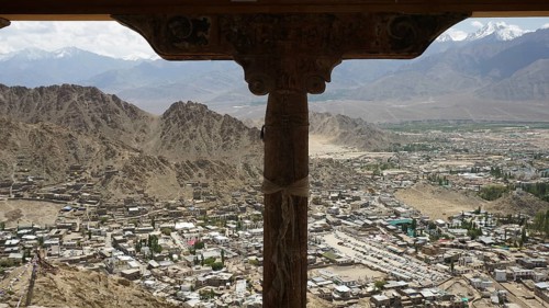 Spectacular mountain view through wooden column with city view under the sky tent, Ladakh,