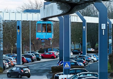 The H Bahn, an automatically controlled large cabin suspension railway above the parking lot of the