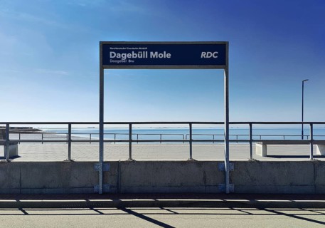Dagebüll Mole sign of the Norddeutsche Eisenbahn Niebüll with a view of the North Sea,