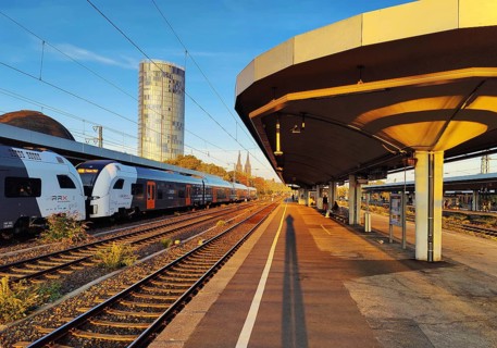 On the train track with a view of the Cologne Triangle skyscraper at sunrise, Deutzer Bahnhof,
