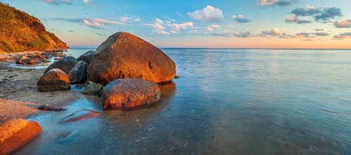 Coastal landscape with large boulders on the Baltic Sea beach in the evening light, Mönchgut Nature